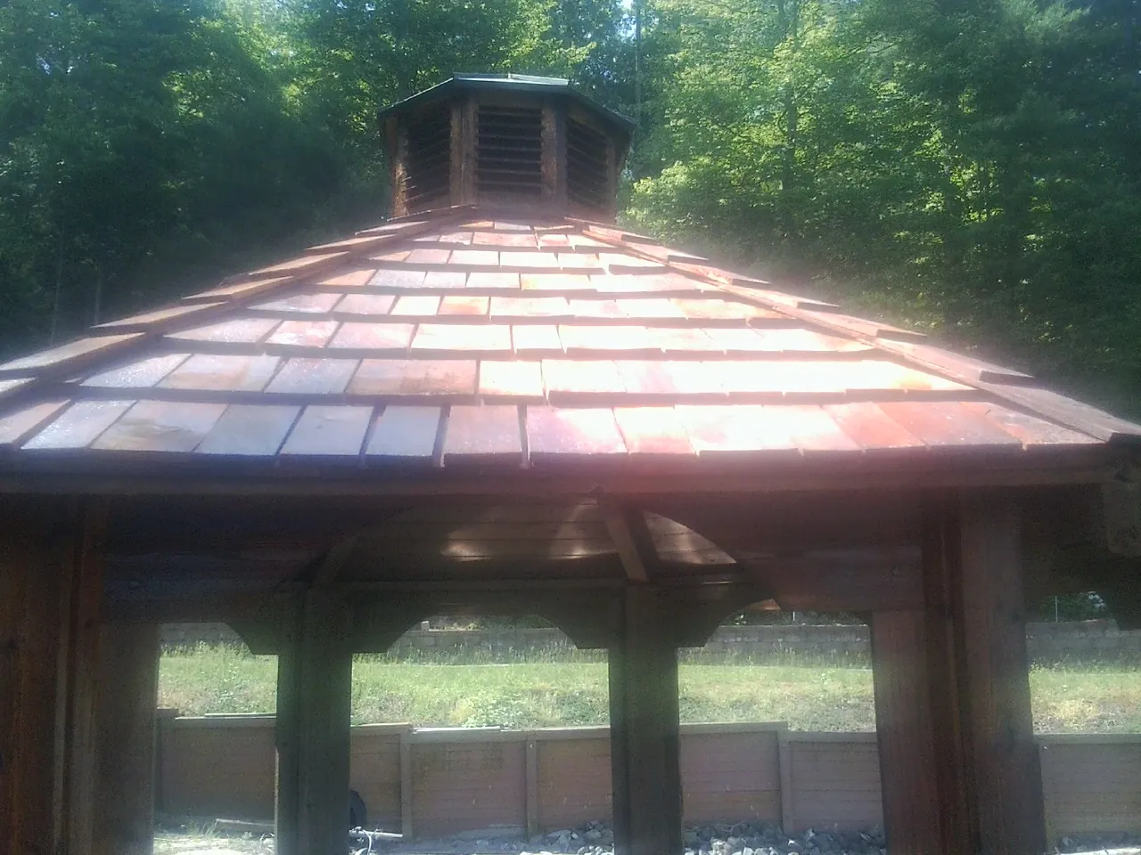 New cedar shake roof and cupola on a lakeside gazebo in Broussard